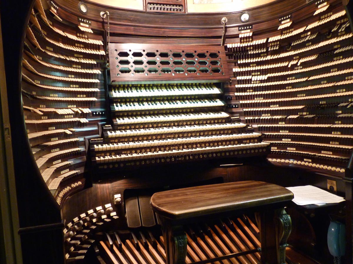 Large musical organ with a bench