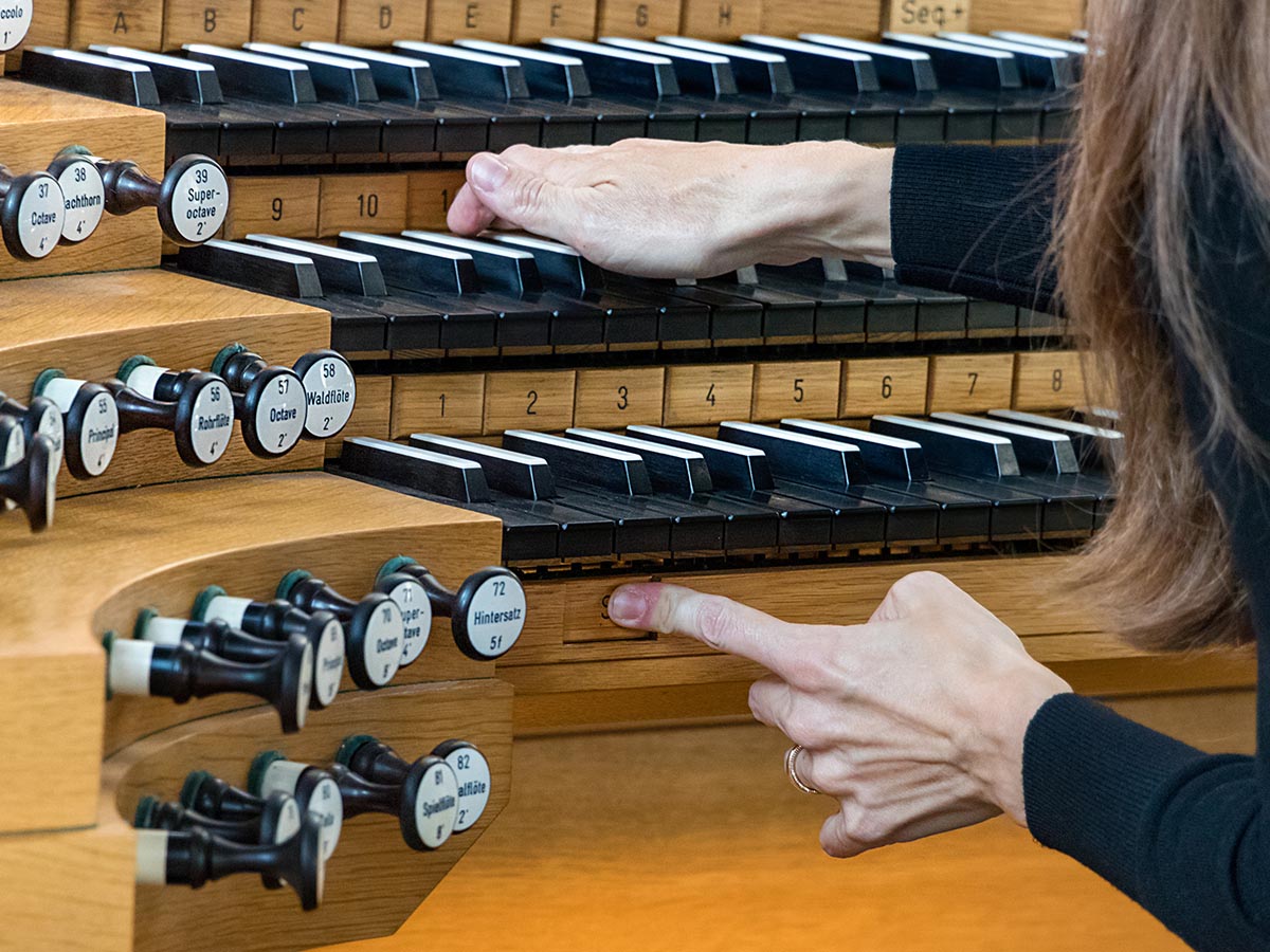 Woman pushing keys on a musical organ